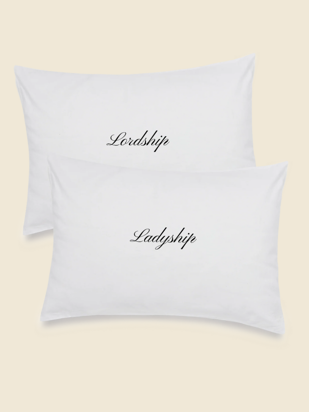white pillowcase set with embroidered words in black saying Lordship and Ladyship