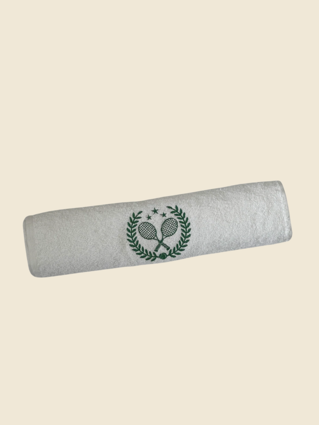 white towel with green embroidered tennis logo