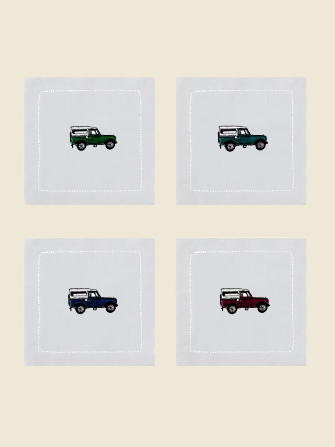 Four square cocktail napkins with embroidered land rover design on a white background