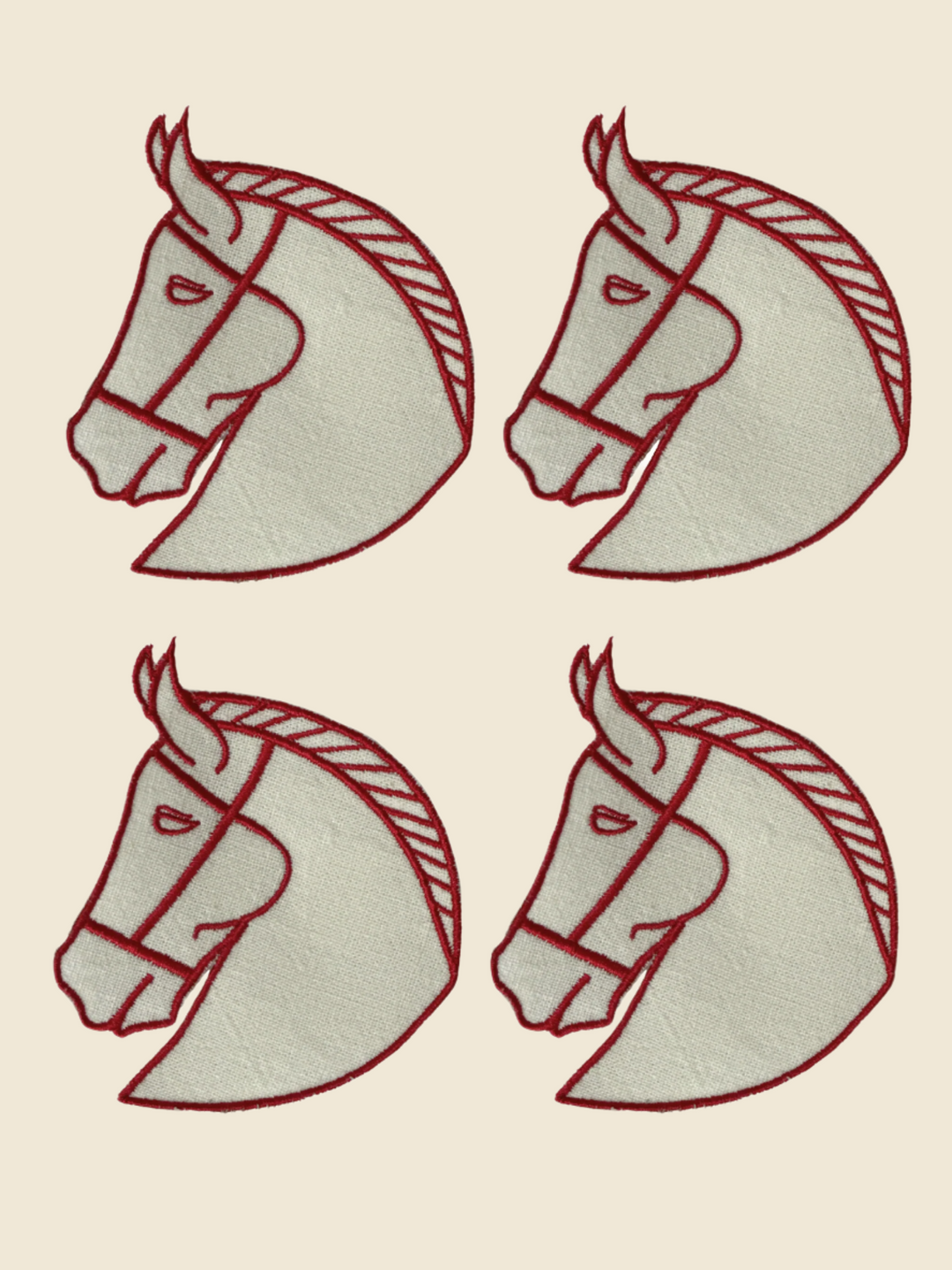 Four embroidered horse head designs on a white background