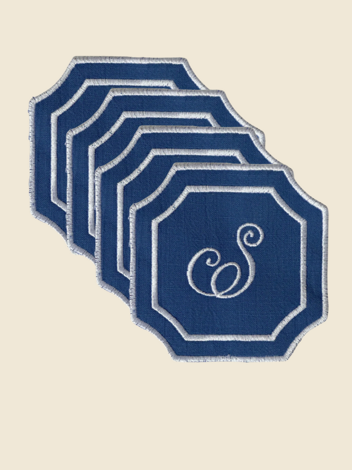 Set of 4 blue coasters with a white letter 'S' on a white background