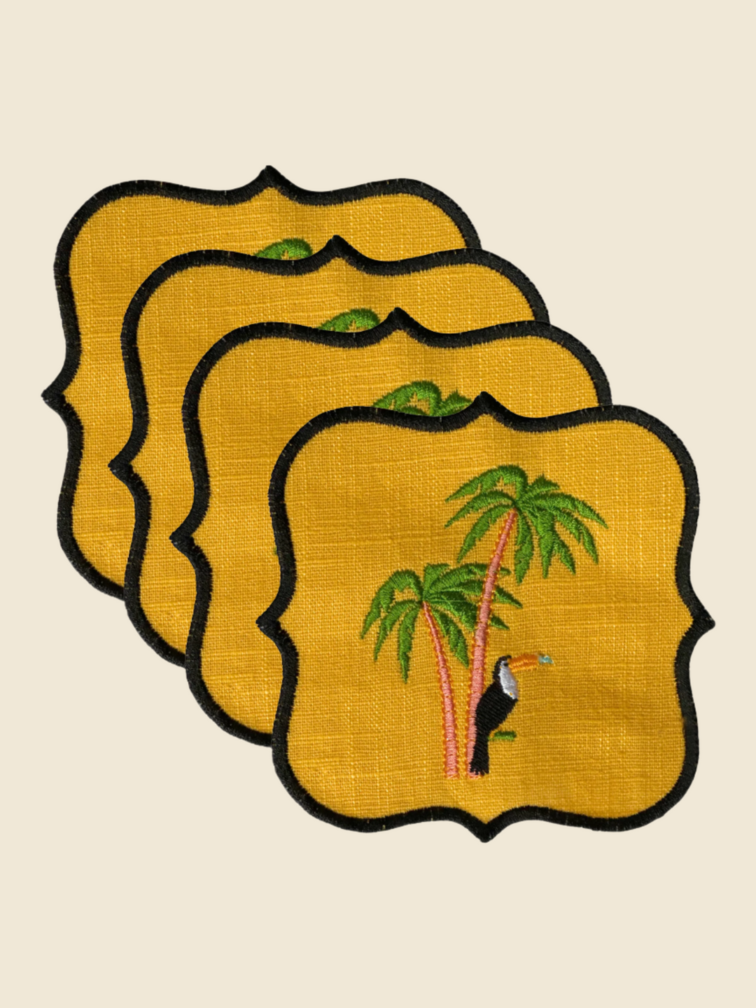 Set of four decorative coasters with tropical design on a yellow background